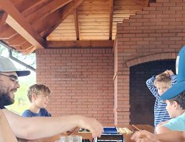 chłopcy wraz z panem Adamem w czasie nauki gry w warcaby