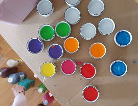 kolorowe farby w pojemnikach na stoliku